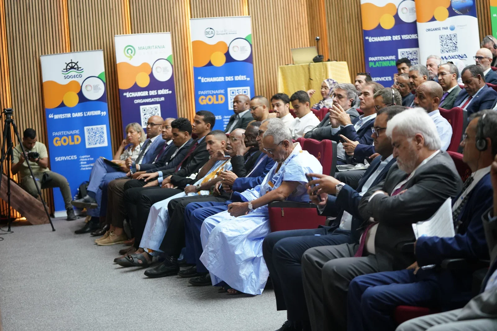 Delegates and partner banners fill the summit hall