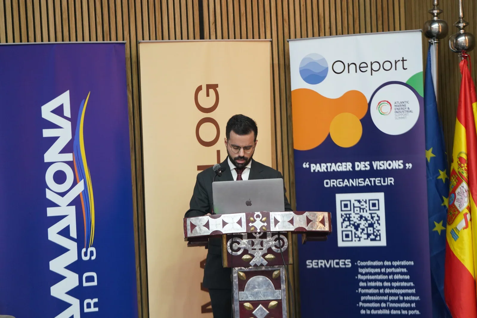 An organiser opens proceedings from the summit lectern